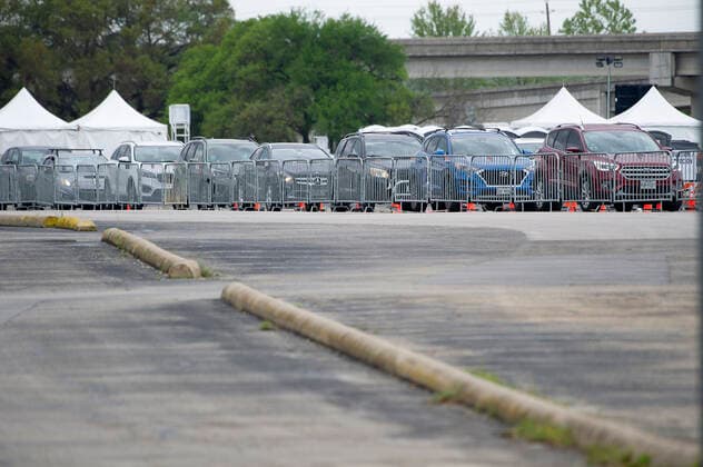 April 03, 2021: Mass drive-thru vaccination site at the Toney Burger Activity Center in South Austin, vehicles wait in line on Saturday evening. Austin, Texas. CSM. Austin United States of America - ZUMAc04_ 1001932920st Copyright: xMarioxCantux