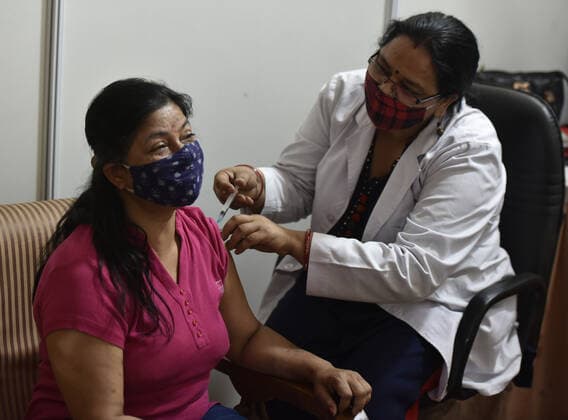 NEW DELHI, INDIA - APRIL 3: A medic administers a dose of COVID-19 vaccine to a beneficiary during a vaccination drive, at Maulana Azad Institute Of Dental Sciences, on April 3, 2021 in New Delhi, India. (Photo by Sonu Mehta Hindustan Times) India Begins Third Phase Of Vaccination Drive