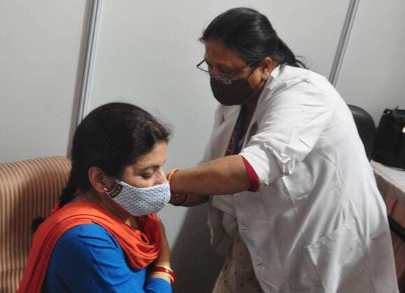 NEW DELHI, INDIA - APRIL 3: Delhi Deputy Chief Minister Manish Sisodia s wife Seema Sisodia receives the first dose of COVID-19 vaccine, during a vaccination drive, at Maulana Azad Institute Of Dental Sciences, on April 3, 2021 in New Delhi, India. (Photo by Sonu Mehta Hindustan Times) India Begins Third Phase Of Vaccination Drive
