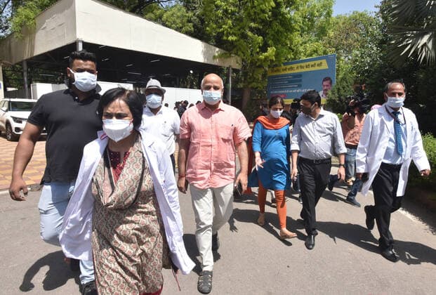 NEW DELHI, INDIA - APRIL 3: Delhi Deputy Chief Minister Manish Sisodia with his wife Seema Sisodia and Dr. Suresh Kumar, Medical Director of LNJP Hospital, leave after receiving first dose of COVID-19 vaccine during the vaccination drive, at Maulana Azad Institute Of Dental Sciences, on April 3, 2021 in New Delhi, India. (Photo by Sonu Mehta Hindustan Times) India Begins Third Phase Of Vaccination Drive