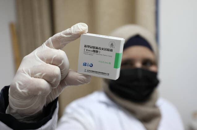 (210404) -- NABLUS, April 4, 2021 -- A health worker displays a box of Sinopharm COVID-19 vaccine during a vaccination campaign in the West Bank city of Nablus, April 4, 2021. China on March 29 handed over a batch of donated Sinopharm COVID-19 vaccines to Palestine to support its nationwide fight against the pandemic. (Photo by Xinhua) MIDEAST-NABLUS-SINOPHARM-COVID-19-VACCINATION AymanxNobani 