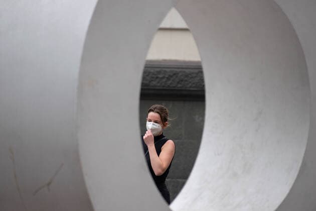 April 4, 2021, Santiago, Metropolitana, Chile: A woman with a mask passes in front of the O of a giant sign that says STGO, in the middle of the total quarantine decreed last week for the Metropolitan Region. Santiago Chile - ZUMAb332 20210404_zip_b332_014 Copyright: xMatiasxBasualdox