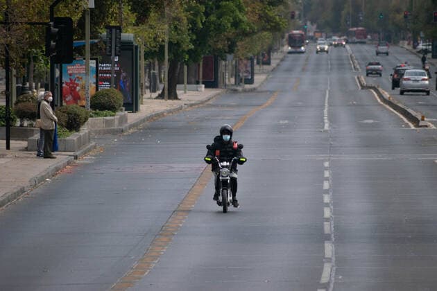 April 4, 2021, Santiago, Metropolitana, Chile: A worker from a delivery application drives on a main street in Santiago, in the midst of the total quarantine decreed last week for the Metropolitan Region. Santiago Chile - ZUMAb332 20210404_zip_b332_023 Copyright: xMatiasxBasualdox