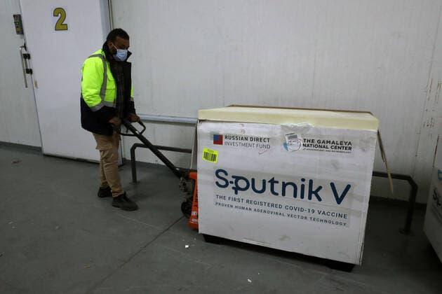 (210404) -- TRIPOLI, April 4, 2021 -- A worker transfers COVID-19 vaccines in Tripoli, Libya, on April 4, 2021. The Libyan Minister of Health Ali Zanati on Sunday announced that a shipment of 101,250 doses of Russia s Sputnik V COVID-19 vaccine, provided by the United Arab Emirates, arrived in Tripoli. (Photo by Xinhua) LIBYA-TRIPOLI-COVID-19 VACCINE-ARRIVAL HamzaxTurkia 