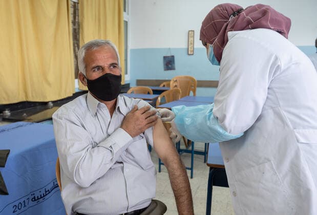 (210406) -- BETHLEHEM, April 6, 2021 -- A Palestinian man receives a dose of Sinopharm COVID-19 vaccine at a medical center during a vaccination campaign launched by the health ministry in the West Bank city of Bethlehem, April 6, 2021. (Photo by Xinhua) MIDEAST-BETHLEHEM-VACCINATION-COVID-19 LuayxSababa 