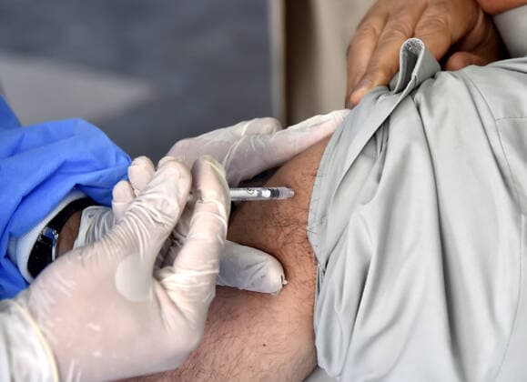(210408) -- PESHAWAR, April 8, 2021 -- A senior citizen receives a dose of COVID-19 vaccine at a vaccination center in northwest Pakistan s Peshawar on April 7, 2021. So far, more than 1 million people have been vaccinated in Pakistan, and the total number of people who have registered themselves for vaccination is now over 2 million, according to the National Command and Operation Center (NCOC) chief Asad Umar. (Photo by Xinhua) PAKISTAN-COVID-19-VACCINATION SaeedxAhmad 