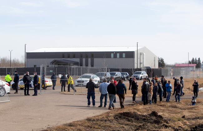April 7, 2021, EDMONTON, ab, Canada: Supporters gather as a fence goes up around GraceLife Church near Edmonton on Wednesday April 7, 2021. The Alberta government has closed down and fenced off a church that has been charged with refusing to follow COVID-19 health rules. Alberta Health Services, in a statement, says GraceLife church will remain closed until it shows it will comply with public-health measures meant to contain the spread of the novel coronavirus. EDMONTON Canada  - ZUMAc35_ 20210407_zaf_c35_059 Copyright: xJasonxFransonx