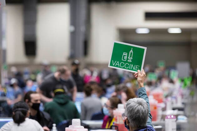 April 7, 2021, Seattle, Washington, USA: A worker signals the next patient in line to receive the first dose of the PfizerÃ¢â‚¬BioNTech COVID-19 vaccine at the Lumen Field Event Center in Seattle on Wednesday, April 7, 2021. The City of Seattle administered a record 7,615 doses of vaccine at the site on Wednesday. Seattle USA - ZUMAg235 20210407_zap_g235_002 Copyright: xPaulxChristianxGordonx