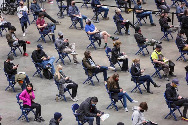 April 7, 2021, Seattle, Washington, USA: Patients wait in the observation area after receiving the first dose of the PfizerÃ¢â‚¬BioNTech COVID-19 vaccine at the Lumen Field Event Center in Seattle on Wednesday, April 7, 2021. The City of Seattle administered a record 7,615 doses of vaccine at the site on Wednesday. Seattle USA - ZUMAg235 20210407_zap_g235_007 Copyright: xPaulxChristianxGordonx