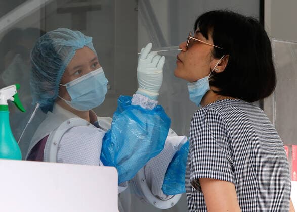 April 8, 2021, Bangkok, Thailand: A health worker collects a nasal swab sample from a woman outside a nightclub in Bangkok..The Ministry of Public Health is set to recommend the closure of night entertainment spots in high-risk areas of Bangkok, in order to deal with the fast-spreading UK variant of the coronavirus. The UK variant is believed to have played a significant role in the spread of the latest cluster of infections detected at entertainment venues across the capital. Bangkok Thailand - ZUMAs197 20210408_zaa_s197_010 Copyright: xChaiwatxSubprasomx