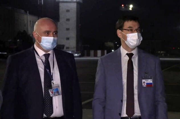 YEREVAN, ARMENIA - APRIL 8, 2021: Pavel Kurochkin (R), a counsellor of the Russian Embassy in Yerevan, welcomes the first batch of the Gam-COVID-Vac (Sputnik V) COVID-19 vaccine at Zvartnots International Airport. The vaccine will be used for vaccination of people at risk of severe COVID-19 illness. Best quality available. Video screen grab. The Republic of Armenia Ministry of Health TASS A STILL IMAGE TAKEN FROM VIDEO PROVIDED BY A THIRD PARTY. EDITORIAL USE ONLY  TS0FBF69