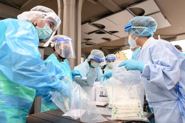 April 8, 2021, Bangkok, Thailand: Health workers wearing personal protective equipment suite (PPE) preparing during a swab test drive outside a nightclub in Bangkok..The Ministry of Public Health is set to recommend the closure of night entertainment spots in high-risk areas of Bangkok, in order to deal with the fast-spreading UK variant of the coronavirus. The UK variant is believed to have played a significant role in the spread of the latest cluster of infections detected at entertainment venues across the capital. Bangkok Thailand - ZUMAs197 20210408_zaa_s197_060 Copyright: xAmpholxThongmueangluangx