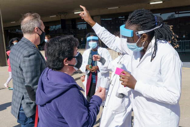 April 8, 2021, Montreal, PQ, Canada: A woman receives a coupon at a COVID-19 vaccination clinic to receive the AstraZeneca vaccine at Olympic Stadium in Montreal, on Thursday, April 8, 2021. Quebecers 55 and over can now get the AstraZeneca vaccine at walk-in clinics across the province. Montreal Canada  - ZUMAc35_ 20210408_zaf_c35_015 Copyright: xPaulxChiassonx