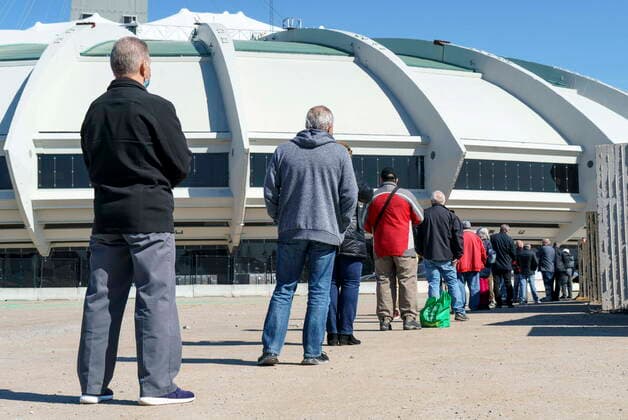 April 8, 2021, Montreal, PQ, Canada: People wait in line at a COVID-19 vaccination clinic to receive the AstraZeneca vaccine at Olympic Stadium in Montreal, on Thursday, April 8, 2021. Quebecers 55 and over can now get the AstraZeneca vaccine at walk-in clinics across the province. Montreal Canada  - ZUMAc35_ 20210408_zaf_c35_012 Copyright: xPaulxChiassonx