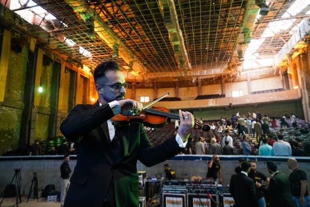 April 8, 2021, Mosul, Nineveh, Iraq: A member of the Watar orchestra playing for the first time on the grounds of the Spring Theatre Hall, which was destroyed during the ISIS occupation in the city..The Watar orchestral includes 36 young men and women from different denominations of Nineveh Governorate, including Muslims, Christians and Yazidis, whose ages range between 8-32 years. Mosul Iraq - ZUMAs197 20210408_zaa_s197_181 Copyright: xIsmaelxAdnanx