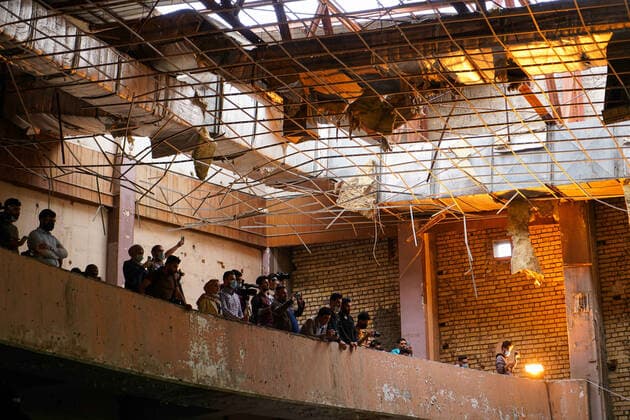 April 8, 2021, Mosul, Nineveh, Iraq: Photographers standing next to a destroyed amphitheatre as the Watar orchestra plays for the first time on the grounds of the Spring Theatre Hall, which was destroyed during the ISIS occupation in the city..The Watar orchestral includes 36 young men and women from different denominations of Nineveh Governorate, including Muslims, Christians and Yazidis, whose ages range between 8-32 years. Mosul Iraq - ZUMAs197 20210408_zaa_s197_175 Copyright: xIsmaelxAdnanx