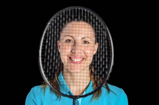 Female athlete posing with badminton racket Happy female athlete posing with badminton racket on black background, model released, Cape Town, South Africa, 14.10.2015, 707832.jpg, isolated, cut out, olympic, olympics, sports, game, sportswear, smiling, holding, badminton, looking through an object, racket, sport, racquet, player, sportswoman, athlete, athletic, physical, fit, fitness, sporty, competition, championship, determination, leisure, activity, focused, vitality, strength, strong, lifestyle, hobby, stamina, wellness, happy, beautiful, confident 20s, Young Adult, Woman, Female, Caucasian, 25-29 Years, Young Women, Caucasian Ethnicity Studio shot,Front view,Close-up,Portrait,Looking at camera,Head and shoulders,Black background