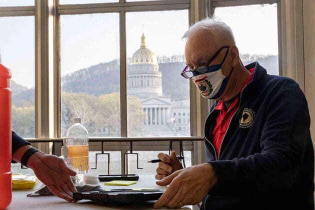 April 8, 2021, Charleston, West Virginia, United States: Rod Johnson, 56, wears a mask with the flag of the state of West Virginia on it during a vaccine effort in Riggleman Hall..The Kanawha-Charleston Health Department led a vaccination effort on the campus of the University of Charleston. 1,800 doses of the Johnson & Johnson Janssen Covid-19 vaccine were on hand to be given out to all persons aged 16 years and older. Charleston United States - ZUMAs197 20210408_zaa_s197_235 Copyright: xStephenxZennerx