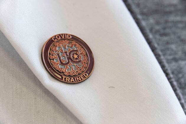 April 8, 2021, Charleston, West Virginia, United States: A COVID TRAINED button from the University of Charleston seen during the vaccination in Riggleman Hall..The Kanawha-Charleston Health Department led a vaccination effort on the campus of the University of Charleston. 1,800 doses of the Johnson & Johnson Janssen Covid-19 vaccine were on hand to be given out to all persons aged 16 years and older. Charleston United States - ZUMAs197 20210408_zaa_s197_252 Copyright: xStephenxZennerx