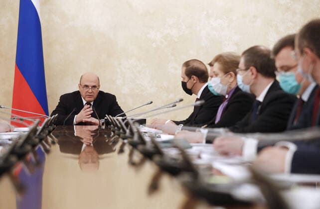 MOSCOW, RUSSIA - APRIL 9, 2021: Russia s Prime Minister Mikhail Mishustin (L) during a meeting on the production and circulation of vaccines against COVID-19 at the House of the Russian Government. Dmitry Astakhov POOL TASS  TS0FC19F