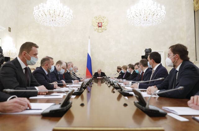 MOSCOW, RUSSIA - APRIL 9, 2021: Russia s Prime Minister Mikhail Mishustin (C) during a meeting on the production and circulation of vaccines against COVID-19 at the House of the Russian Government. Dmitry Astakhov POOL TASS  TS0FC1A3