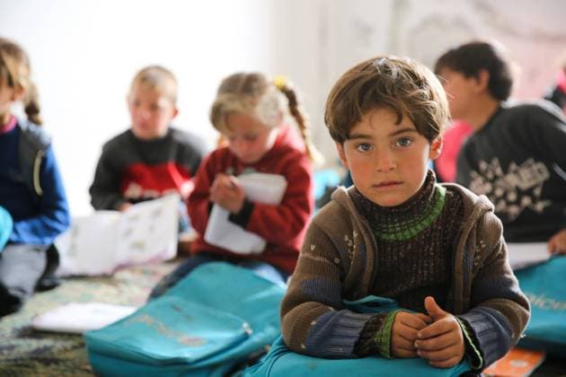 April 7, 2021: Atarib, Syria. 7 April 2021. Children attend a school in the village of Sahara, near the town of Atarib in the western Aleppo countryside. During the classes children sit on the floor as the building lacks in desks and chairs and other school facilities. The students attending the lessons are from the village of Basratun, which was recaptured by the Syrian army in April 2020 during a major military campaign by the Syrian government forces to retake territories in western Aleppo and in the Idlib governorate from the rebels. According to Unicef, at the beginning of this academic year over 1.7 million children in war-torn Syria did not have access to schooling, while 1.3 million children were at risk of dropping out - ZUMAd99_ 20210407_zap_d99_012 Copyright: xJumaxMohammadx