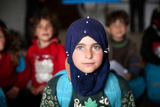 April 7, 2021: Atarib, Syria. 7 April 2021. Children attend a school in the village of Sahara, near the town of Atarib in the western Aleppo countryside. During the classes children sit on the floor as the building lacks in desks and chairs and other school facilities. The students attending the lessons are from the village of Basratun, which was recaptured by the Syrian army in April 2020 during a major military campaign by the Syrian government forces to retake territories in western Aleppo and in the Idlib governorate from the rebels. According to Unicef, at the beginning of this academic year over 1.7 million children in war-torn Syria did not have access to schooling, while 1.3 million children were at risk of dropping out - ZUMAd99_ 20210407_zap_d99_023 Copyright: xJumaxMohammadx