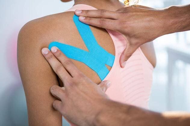 Physiotherapist sticking tape on female patient Physiotherapist sticking tape on female patient in clinic, model released, Cape Town, South Africa, 01.06.2016, 805298.jpg, medical, clinic, hospital, physio, physiotherapy, physiotherapist, orthopedic, physical therapy, therapy, physical therapist, doctor, specialist, profession, professional, patient, casual clothing, sticking, assisting, kinesiotape, kinesiotaping, back, shoulder, back pain, illness, assistance, treatment, cure, recovery, health, health service, bodycare, healthcare, healthcare and medicine, expertise Baby, Girl, Female, Mixed-Race, 30s, Mid Adult, Man, Male, Caucasian, 0-1 Months, Baby Girls, Mixed-Race Person, 30-34 Years, Mid Adult Men, Caucasian Ethnicity Indoors