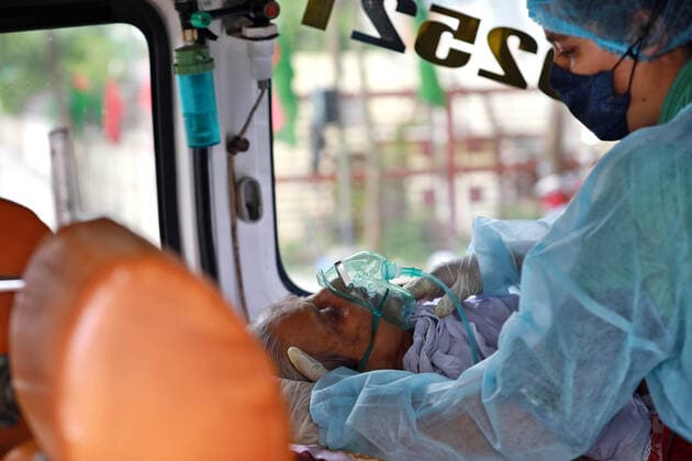April 9, 2021, Dhaka, Dhaka, Bangladesh: April, 09,2021 A relative of a woman who has infected by the COVID-19 and she wearing a protective suit help to elderly woman in an ambulance, Dhaka, Bangladesh Dhaka Bangladesh - ZUMAr338 20210409_zip_r338_021 Copyright: xHarun-Or-Rashidx