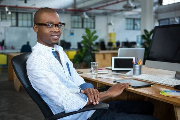 Graphic designer at desk Portrait of graphic designer at desk in office, model released, , property released, Cape Town, South Africa, 16.10.2016, 898274.jpg, office, workplace, executive, profession, professional, occupation, corporate, company, reliability, job, career, expertise, skill, business, smart casual, graphic designer, artist, creative, sitting, work, working, desk, spectacle, color swatch, digital tablet, computer, monitor, desktop pc, electronic, personal computer, keyboard, mouse, graphics tablet, digitizer, device, technology, confident, confidence, smiling, content, happy, lifestyle