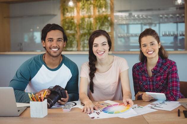 Portrait of happy graphic designers sitting at desk Portrait of happy graphic designers sitting at desk in office, model released, , property released, Cape Town, South Africa, 27.11.2016, 919040.jpg, office, workplace, graphic designer, creative business, profession, professional, executive, occupation, job, career, expertise, corporate, business, businessman, businesswoman, colleague, coworker, reliability, company, strategy, team, teamwork, casual clothing, sitting, smiling, happy, cheerful, smartphone, wireless technology, communication, connection, holding, laptop, graph, document, digital camera, pencil holder, pencil, graphic, photo, color swatch, handsome, beautiful, leisure, lifestyle, creative, modern, youth, confidence