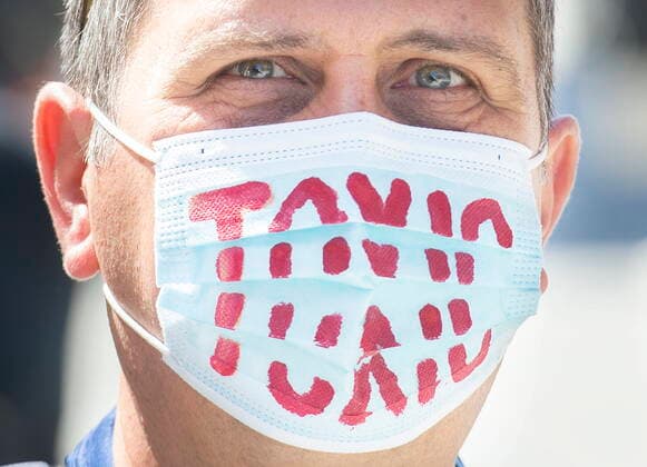 April 10, 2021, Montreal, PQ, Canada: A man wears a face mask reading Ã¢â‚¬ËœToxicÃ¢â‚¬â ¢ during a demonstration in Montreal, Saturday, April 10, 2021, opposing the Quebec governmentÃ¢â‚¬â ¢s health and safety measures to curb the spread of Covid-19 in schools as the COVID-19 pandemic continues in Canada and around the world. Montreal Canada  - ZUMAc35_ 20210410_zaf_c35_014 Copyright: xGrahamxHughesx