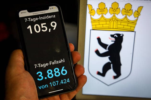 Coronavirus in Deutschland - Covid-19-Dashboard des Robert Koch-Institut DEU, Deutschland, Berlin, 11.04.2021: Die 7-Tage-Inzidenz für das Bundesland (Fälle letzte 7 Tage 100.000 EW) wird auf einem iPhone angezeigt, im Hintergrund das Landeswappen