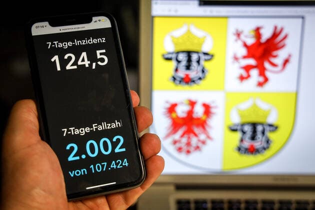 Coronavirus in Deutschland - Covid-19-Dashboard des Robert Koch-Institut DEU, Deutschland, Meckenburg-Vorpommern, 11.04.2021: Die 7-Tage-Inzidenz für das Bundesland (Fälle letzte 7 Tage 100.000 EW) wird auf einem iPhone angezeigt, im Hintergrund das Landeswappen