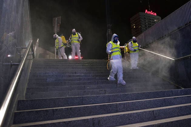 April 11, 2021, Warsaw, Poland: Cleaning service workers wearing protective suits are seen disinfecting one of the most frequently used underpass in Warsaw..At night, the municipal cleaning services disinfect the most important and most frequently used communication routes in the center of Warsaw. Disinfection was carried out with highly ozonated water - it is an innovative Polish method..Disinfection of Warsaw was performed due to the covid 19 pandemic, the third wave of the virus is currently raging in Poland, there is a shortage of places in hospitals and the average daily number of new cases is around 30,000, while deaths are over 600. Warsaw Poland - ZUMAs197 20210411_zaa_s197_002 Copyright: xAttilaxHusejnowx