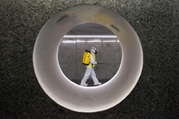 April 11, 2021, Warsaw, Poland: Cleaning service workers are seen disinfecting one of the most frequently used underpass in Warsaw..At night, the municipal cleaning services disinfect the most important and most frequently used communication routes in the center of Warsaw. Disinfection was carried out with highly ozonated water - it is an innovative Polish method..Disinfection of Warsaw was performed due to the covid 19 pandemic, the third wave of the virus is currently raging in Poland, there is a shortage of places in hospitals and the average daily number of new cases is around 30,000, while deaths are over 600. Warsaw Poland - ZUMAs197 20210411_zaa_s197_016 Copyright: xAttilaxHusejnowx