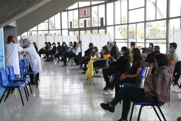 (210411) -- TUNIS, April 11, 2021 -- People wait to receive COVID-19 vaccines at a vaccination center in a gymnasium in Tunis, Tunisia, April 10, 2010. (Photo by Xinhua) TUNISIA-TUNIS-COVID-19-VACCINATION AdelxEzzine 