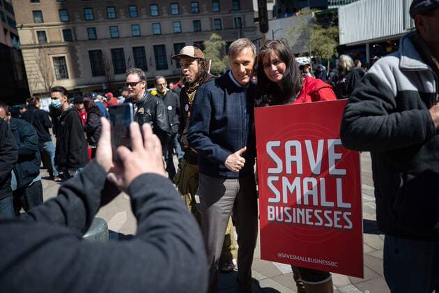 April 11, 2021, Vancouver, BC, Canada: People s Party Leader Maxime Bernier, centre, poses for a photograph with a supporter during an Open Up Canada rally and march held by people opposed to public health guidelines in place to curb the spread of COVID-19, in Vancouver, on Sunday, April 11, 2021. Vancouver Canada - ZUMAc35_ 20210411_zaf_c35_064 Copyright: xDarrylxDyckx