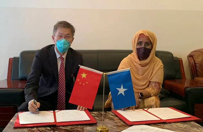 (210412) -- MOGADISHU, April 12, 2021 -- Qin Jian (L), Chinese Ambassador to Somalia, and Somalia s Minister of Health and Human Services Fawziya Abikar Nur sign handover certificates of COVID-19 vaccines donated by China in Mogadishu, capital of Somalia, April 11, 2021. Somalia on Sunday received 200,000 doses of Sinopharm vaccine donated by China to boost the war against COVID-19 pandemic in the Horn of African State. ( Handout via Xinhua) SOMALIA-MOGADISHU-CHINA-DONATED SINOPHARM VACCINES ChinesexEmbassyxinxSomalia 