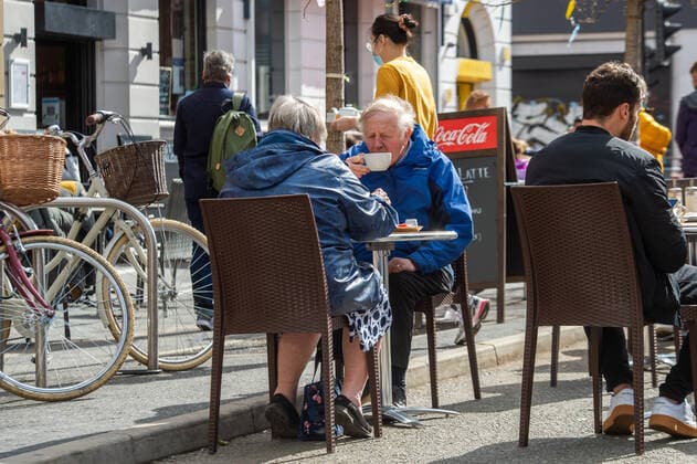 People eat and drink at tables outside a restaurant on Stevenson Square in city centre Manchester on 12 April 2021. Customers have returned to the High Street on Monday as non-essential retailers in England and Wales reopened after more than three months of lockdown restrictions due to the Covid-19 pandemic. Manchester Greater Manchester England City Centre  Copyright: xMattxWilkinsonx