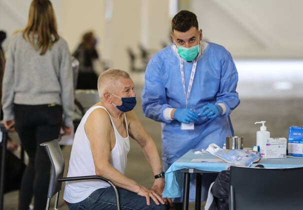 PXL_Mass vaccination in Zagreb A member of the medical staff vaccinates a patient during a mass vaccination at Zagreb Fair hall in Zagreb,Croatia on April 12, 2021.By the end of the day 5,000 citizens should receive the AstraZeneca COVID-19 vaccine JuricaxGaloic PIXSELL