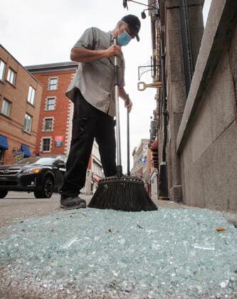 April 12, 2021, Montreal, PQ, Canada: Carlos Londono cleans up broken glass after last night s anti-Covid-19 curfew riot Monday, April 12, 2021 in Montreal. Montreal Canada  - ZUMAc35_ 20210412_zaf_c35_005 Copyright: xRyanxRemiorzx