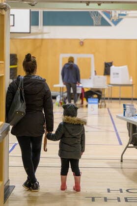 April 12, 2021: A woman and child wait to enter a Whitehorse polling station during the Yukon election on Monday April 12, 2021. Polls have opened across Yukon as the Liberal government led by Sandy Silver seeks a second term.  - ZUMAc35_ 20210412_zaf_c35_082 Copyright: xMarkxKellyx