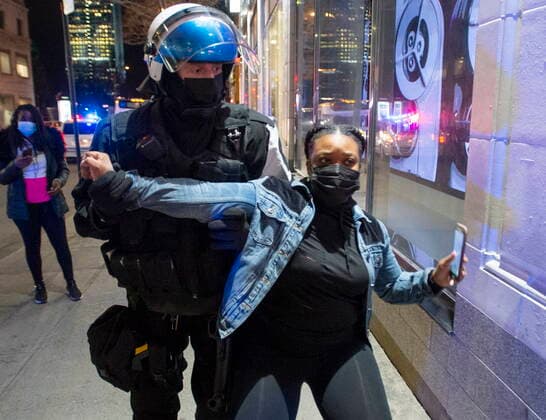 April 12, 2021, Montreal, PQ, Canada: Police try and detain a woman as anti-curfew protests continue for a second night Monday, April 12, 2021 in Montreal. Montreal Canada  - ZUMAc35_ 20210412_zaf_c35_096 Copyright: xRyanxRemiorzx