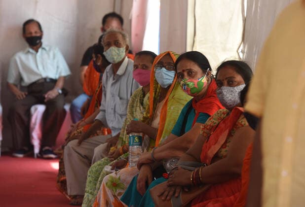 NEW DELHI, INDIA - APRIL 12: People wait in queue to get vaccinated against Covid-19, on the second day of Tika Utsav , at Rajiv Gandhi Super Specialty Hospital, on April 12, 2021 in New Delhi, India. (Photo by Raj K Raj Hindustan Times) Over 40 lakh People Vaccinated On Second Day Of Tika Utsav