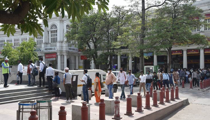 NEW DELHI, INDIA - APRIL 12: Commuters wait in a long queue outside Rajiv Chowk Metro Station after DMRC allowed travelers to enter in small groups as a preventive measure against the Covid-19 coronavirus, at Connaught Place, on April 12, 2021 in New Delhi, India. (Photo by Sonu Mehta Hindustan Times) Daily Life Amid Rise In Coronavirus Cases In India