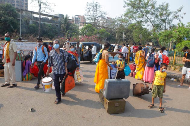 April 14, 2021, Mumbai, Maharshtra, INDIA: 14 April 2021 - Mumbai - INDIA..A migrant worker with luggage & Family arrive at the Lokmanya Tilak Train station in an attempt to take a train to his village..Migrants in their thousands are Fleeing out of Mumbai & other big cities of INDIA back to their Villages in fear of a Total Lock down..Migrants fear a repeat of the events of last year when many had a tortuous experience when they tracked about 1500 kms back to their villages on FOOT when the 1st lock down was announced. Mumbai INDIA - ZUMAsu5_ 20210414_zap_su5_013 Copyright: xSubhashxSharmax