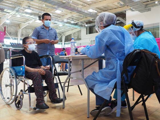 April 17, 2021, Lima, Lima, Peru: Elderly woman ina wheelchair being inoculated with the Covid-19 vaccine in a sports center. The Peruvian Government enabled the sports venues of the Lima 2019 Pan American Games as vaccination centers. Lima Peru - ZUMAg240 20210417_zip_g240_008 Copyright: xCarlosxGarciaxGranthonx