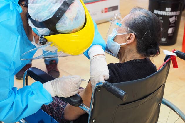 April 17, 2021, Lima, Lima, Peru: Elderly woman being inoculated with the Covid-19 vaccine in a sports center. The Peruvian Government enabled the sports venues of the Lima 2019 Pan American Games as vaccination centers. Lima Peru - ZUMAg240 20210417_zip_g240_011 Copyright: xCarlosxGarciaxGranthonx