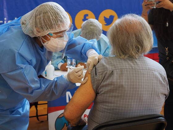 April 17, 2021, Lima, Lima, Peru: Elderly woman being inoculated with the Covid-19 vaccine in a sports center. The Peruvian Government enabled the sports venues of the Lima 2019 Pan American Games as vaccination centers. Lima Peru - ZUMAg240 20210417_zip_g240_016 Copyright: xCarlosxGarciaxGranthonx